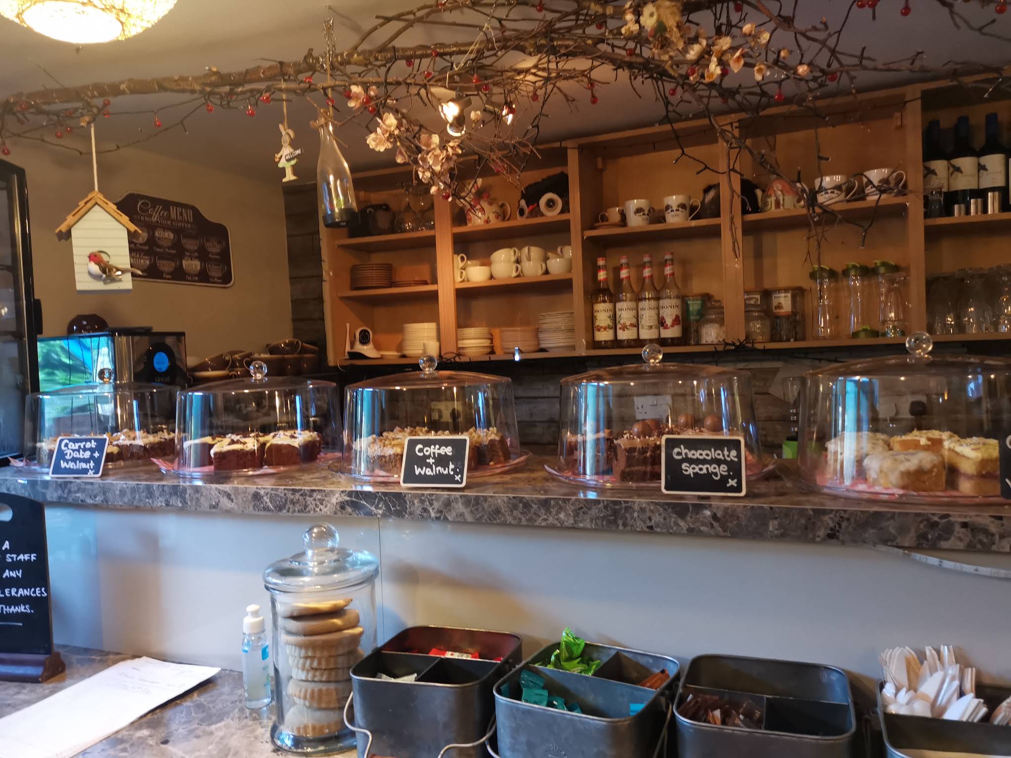 The Lanes’ wooden shelves, hanging greenery and full cake counter